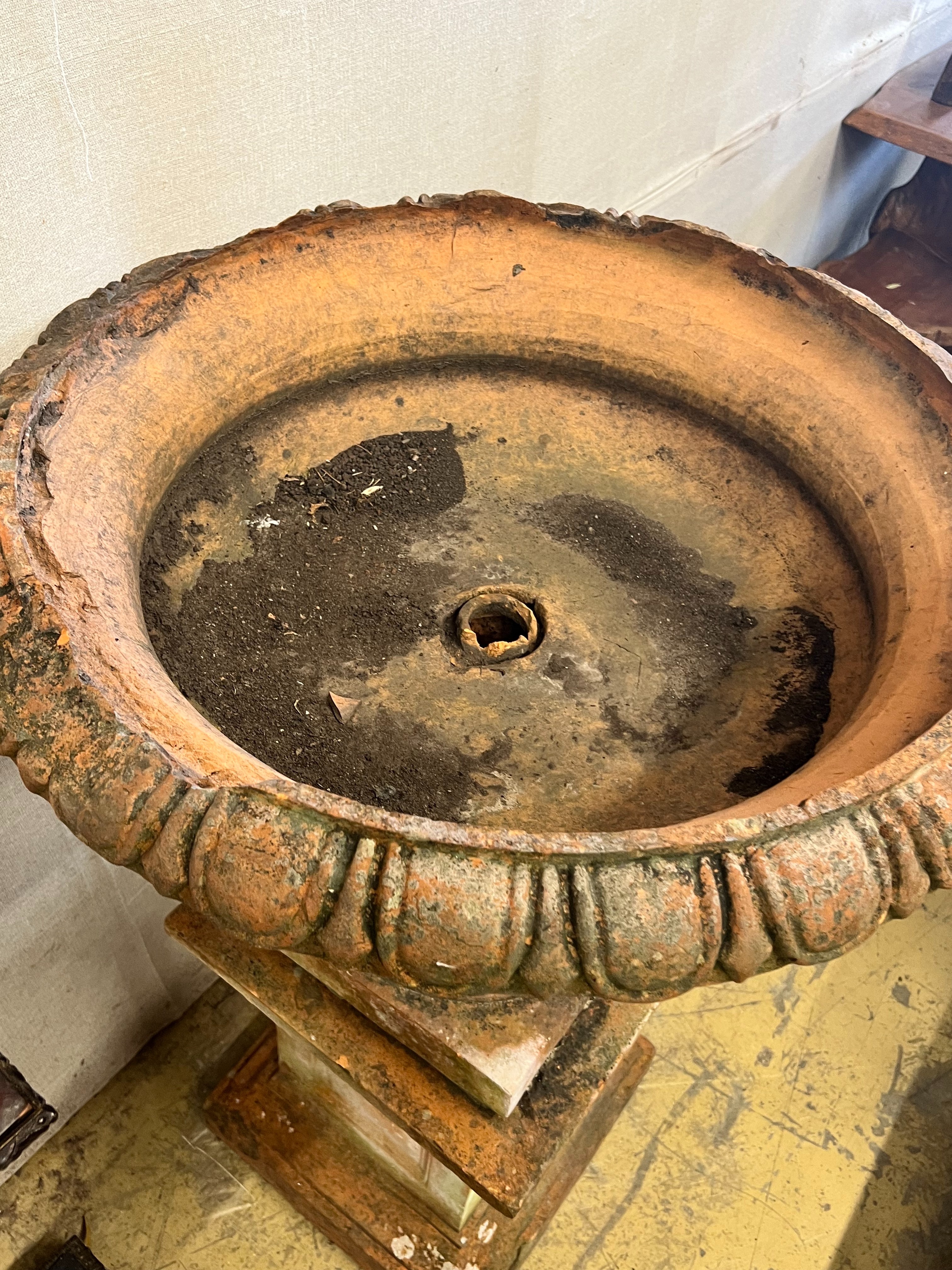 A large terracotta circular campana garden urn on plinth base, diameter 78cm height 118cm